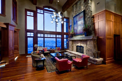 Example of a large arts and crafts formal and open concept medium tone wood floor living room design in Salt Lake City with beige walls, a standard fireplace, a stone fireplace and no tv