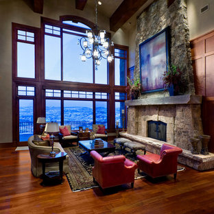 Example of a large arts and crafts formal and open concept medium tone wood floor living room design in Salt Lake City with beige walls, a standard fireplace, a stone fireplace and no tv