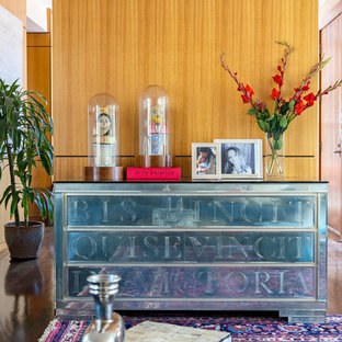 Example of a large mid-century modern open concept medium tone wood floor and brown floor living room design in Denver with beige walls and no fireplace