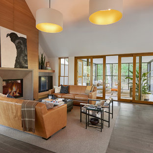 Inspiration for a large contemporary open concept gray floor and medium tone wood floor living room remodel in Grand Rapids with white walls, a standard fireplace, a concrete fireplace and a tv stand