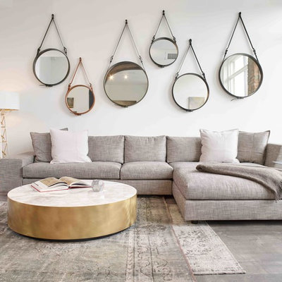 Example of a large danish open concept concrete floor and gray floor living room design in Cincinnati with white walls, no fireplace and no tv
