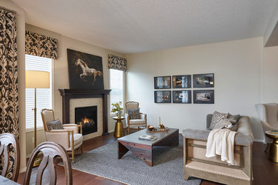 Example of a mid-sized minimalist open concept medium tone wood floor living room design in Calgary with beige walls, a standard fireplace, a tile fireplace and no tv