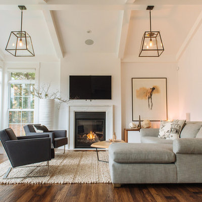 Living room - transitional medium tone wood floor living room idea in Other with white walls, a standard fireplace and a wall-mounted tv