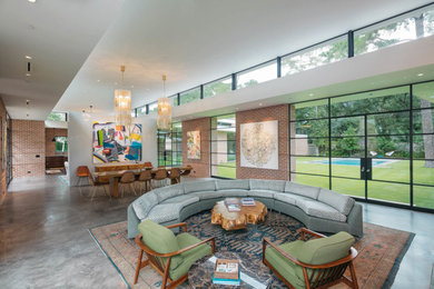 Example of a mid-sized urban formal and open concept concrete floor and gray floor living room design in Austin with beige walls, a standard fireplace, a brick fireplace and no tv