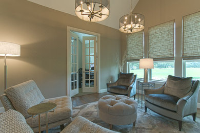 Inspiration for a transitional medium tone wood floor living room library remodel in Dallas with beige walls