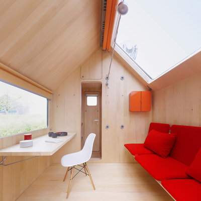 Inspiration for a small modern light wood floor living room remodel in Other