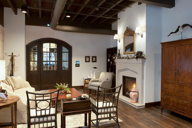 Example of a mid-sized transitional formal and open concept medium tone wood floor living room design in Grand Rapids with white walls and a standard fireplace