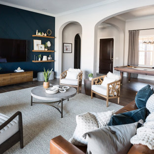 Inspiration for a mid-sized eclectic open concept brown floor living room remodel in Phoenix with blue walls and a wall-mounted tv