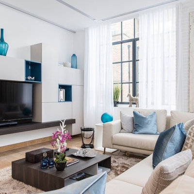 Trendy brown floor living room photo in London with white walls and a wall-mounted tv