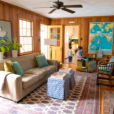 Example of a mid-sized eclectic enclosed medium tone wood floor living room design in Richmond with a standard fireplace and a wall-mounted tv