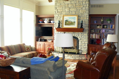 Photo of a traditional living room in St Louis with beige walls, medium hardwood flooring, a standard fireplace and no tv.