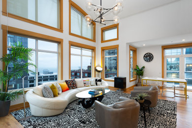 Example of a loft-style brown floor living room design in Seattle with white walls