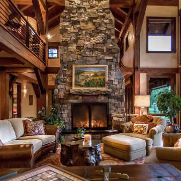 Dramatic wood burning stone fireplace is the living rooms focal point