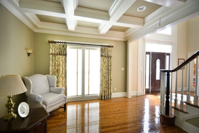Пример оригинального дизайна: большая открытая гостиная комната в классическом стиле с бежевыми стенами, паркетным полом среднего тона и с книжными шкафами и полками без камина, телевизора