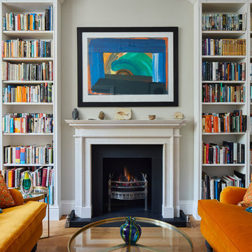 A striking, bold and colourful drawing room was created with bespoke bookshelves