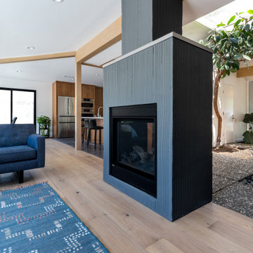 Dual Freestanding Fireplace with Textured Surround Featured in Living Room
