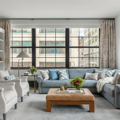 Example of a mid-sized classic formal and enclosed light wood floor and brown floor living room design in New York with gray walls, a media wall and no fireplace