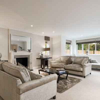 Example of a mid-sized trendy formal carpeted and beige floor living room design in Buckinghamshire with beige walls, a standard fireplace, a metal fireplace and no tv