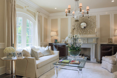 Example of a large classic formal and enclosed dark wood floor living room design in Charlotte with beige walls and a standard fireplace