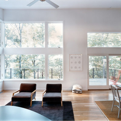 Large trendy open concept light wood floor living room photo in Philadelphia with white walls, a standard fireplace, a tile fireplace and no tv