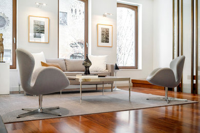 Large 1950s open concept medium tone wood floor living room photo in New York with white walls