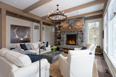 Photo of a large rustic open plan living room in Toronto with white walls, medium hardwood flooring, a stone fireplace surround and no tv.