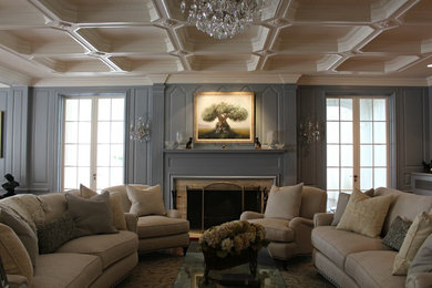 Large traditional living room in New York with blue walls and a stone fireplace surround.