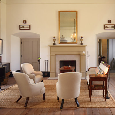 Cottage medium tone wood floor living room photo in Houston with a music area, beige walls and a standard fireplace