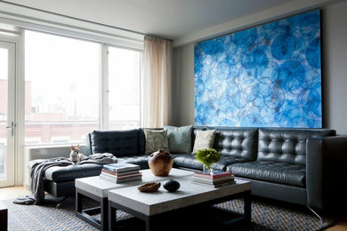 Example of a mid-sized trendy formal and open concept light wood floor living room design in New York with blue walls and a wall-mounted tv