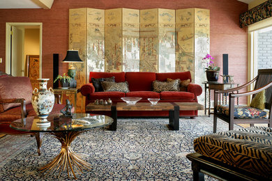 Photo of a large world-inspired formal enclosed living room in Nashville with red walls and no tv.
