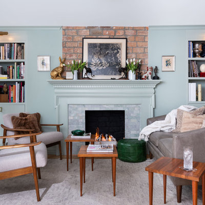 Inspiration for a mid-sized eclectic open concept light wood floor living room library remodel in New York with green walls, a standard fireplace, no tv and a tile fireplace