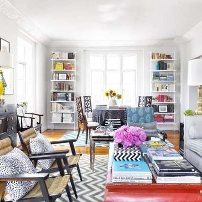 Inspiration for an eclectic open concept medium tone wood floor living room remodel in Los Angeles with white walls and a bar
