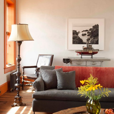 Eclectic medium tone wood floor living room photo in New York with white walls