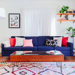 Inspiration for a mid-sized eclectic formal and open concept medium tone wood floor living room remodel in Los Angeles with white walls, no fireplace and no tv