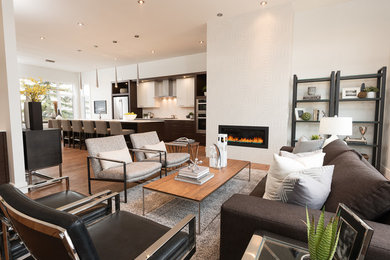 Mid-sized minimalist open concept medium tone wood floor living room photo in Calgary with a standard fireplace and a tile fireplace