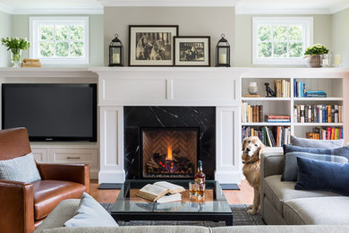 Photo of a contemporary open plan living room in Minneapolis with white walls, medium hardwood flooring, a standard fireplace, a tiled fireplace surround and a built-in media unit.