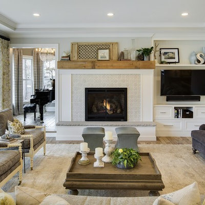 Inspiration for a timeless formal and enclosed medium tone wood floor living room remodel in Minneapolis with gray walls, a standard fireplace, a tile fireplace and a wall-mounted tv