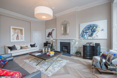 Photo of a living room in Edinburgh with beige walls and light hardwood flooring.