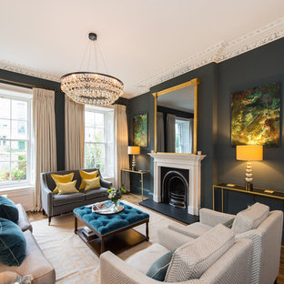 Classic formal living room in Other with black walls, dark hardwood flooring and a standard fireplace.