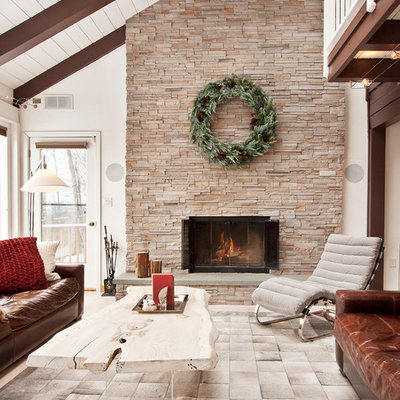 Example of a large mountain style formal and open concept living room design in New York with a standard fireplace, a stone fireplace and no tv