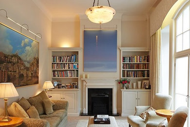 This is an example of a small traditional formal enclosed living room in London with beige walls, carpet, a standard fireplace, a wooden fireplace surround and beige floors.