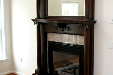 Classic living room in Philadelphia with a standard fireplace, a wooden fireplace surround and no tv.