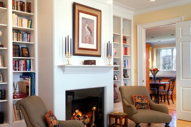 Example of a large country medium tone wood floor living room design in DC Metro with yellow walls and a standard fireplace