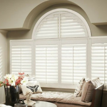 Elegant Shutters for a Window Seat in a Neutral-Palette Living Room