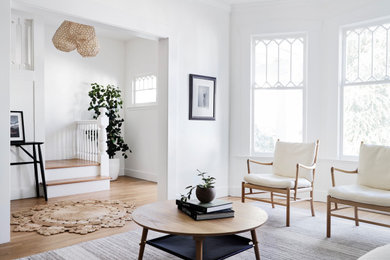 Inspiration for a mid-sized scandinavian formal and enclosed medium tone wood floor and brown floor living room remodel in San Francisco with white walls, a corner fireplace, a tile fireplace and no tv