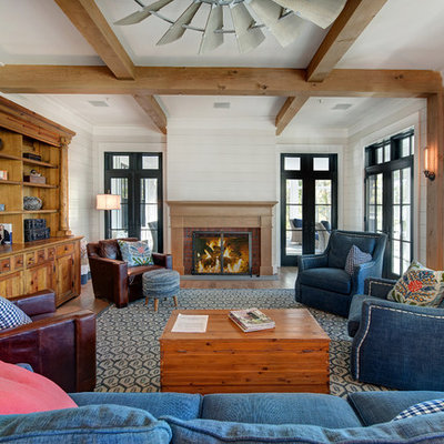 Example of a large beach style open concept medium tone wood floor and brown floor living room design in Baltimore with gray walls, a standard fireplace, a brick fireplace and no tv