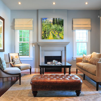 Inspiration for a mid-sized timeless medium tone wood floor living room remodel in Vancouver with blue walls and a standard fireplace