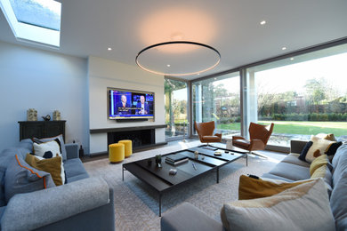 This is an example of a large contemporary enclosed living room in Surrey with a standard fireplace.