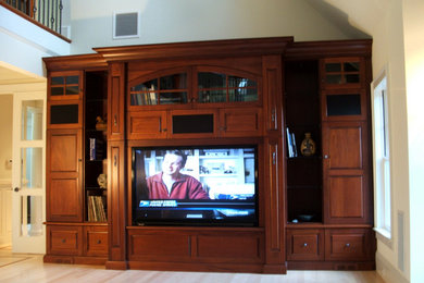 Large transitional loft-style light wood floor living room library photo in Boston with beige walls and a media wall