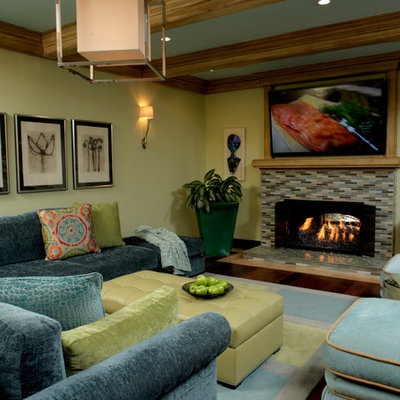 Large elegant open concept dark wood floor living room photo in Orange County with green walls, a standard fireplace, a tile fireplace, a bar and a wall-mounted tv